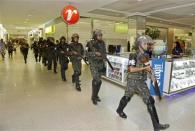 Soldiers patrol a shopping center in the city center during a police strike in Salvador, Bahia state, April 17, 2014. REUTERS/Valter Pontes