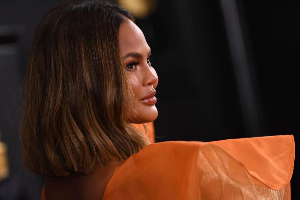 Chrissy Teigen has jumped on board with this denim trend — here's why you should too. (Photo by VALERIE MACON/AFP via Getty Images)