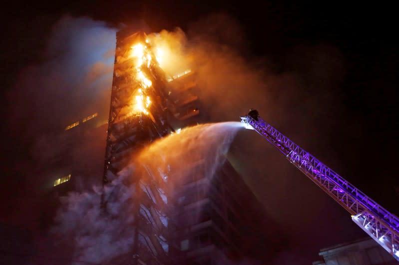 The corporate building of the multinational energy company ENEL, is seen on fire during a protest against the increase in the subway ticket prices in Santiago