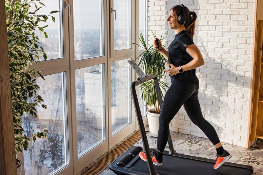 A woman works out on a treadmill. 
