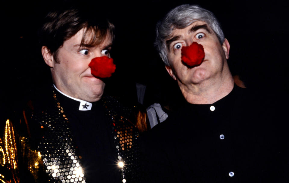 LONDON, ENGLAND - MARCH 14: Father Ted's co-presenters Ardal O'Hanlon and Dermot Morgan during the Red Nose Day telethon on March 14, 1997 in London, England.  The event raised over € 27 million for charitable causes.  (Photo by Mauro Carraro / Comic Relief via Getty Images)
