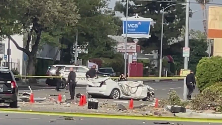 The white Tesla involved in the single-vehicle crash had six occupants and three were killed.  Investigators were on site on May 11, 2024. (KTLA)