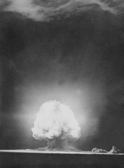 A black and white image of a mushroom cloud.