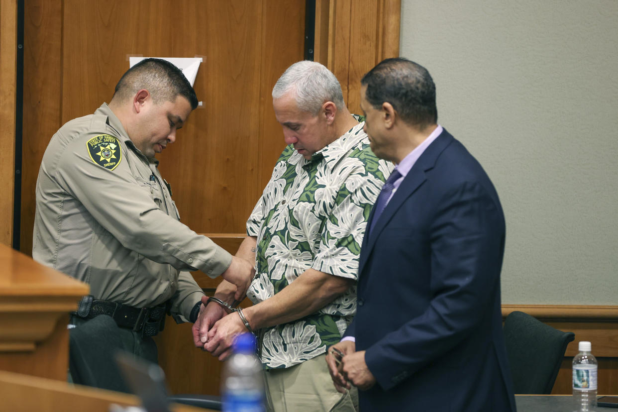 A court officer removes Albert "Ian" Schweitzer's handcuffs following the judge's decision to release him from prison immediately after his attorneys presented new evidence at a hearing Tuesday, Jan. 24, 2023, in Hilo, Hawaii and argued that he didn’t commit the crimes he was convicted of and spent more than 20 years locked up for: the 1991 murder, kidnapping and sexual assault of a woman visiting Hawaii. (Marco Garcia/The Innocence Project via AP Images)