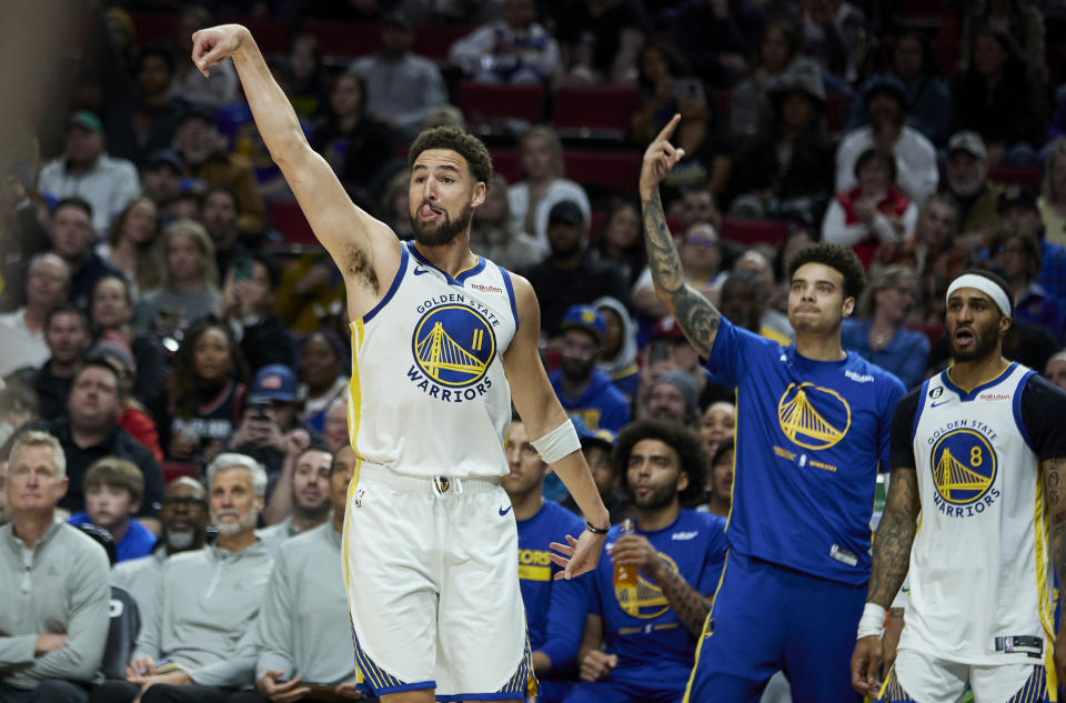 Golden State Warriors guard Klay Thompson reacts after making a 3-point basket against the Portland Trail Blazers during the second half of an NBA basketball game in Portland, Ore., Sunday, April 9, 2023. (AP Photo/Craig Mitchelldyer)