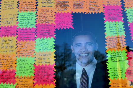 Messages are seen next to a cut-out of former U.S. President Barack Obama at a local shop during President Day holiday in Washington U.S., February 20, 2017. REUTERS/Carlos Barria