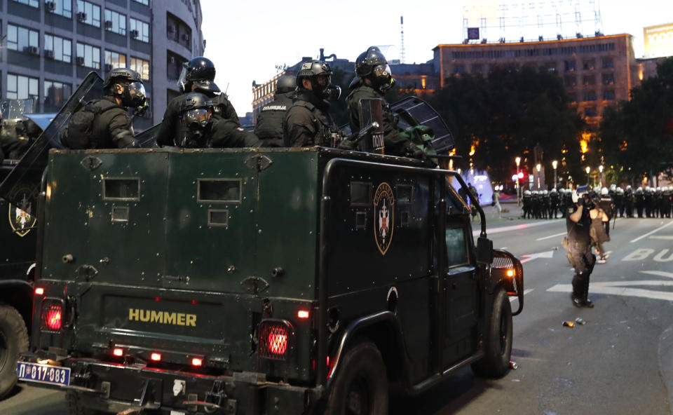 Serbian security forces guard the area during clashes with protesters in Belgrade, Serbia, Wednesday, July 8, 2020. Serbia's president Aleksandar Vucic backtracked Wednesday on his plans to reinstate a coronavirus lockdown in Belgrade after thousands protested the move and violently clashed with the police in the capital. (AP Photo/Darko Vojinovic)