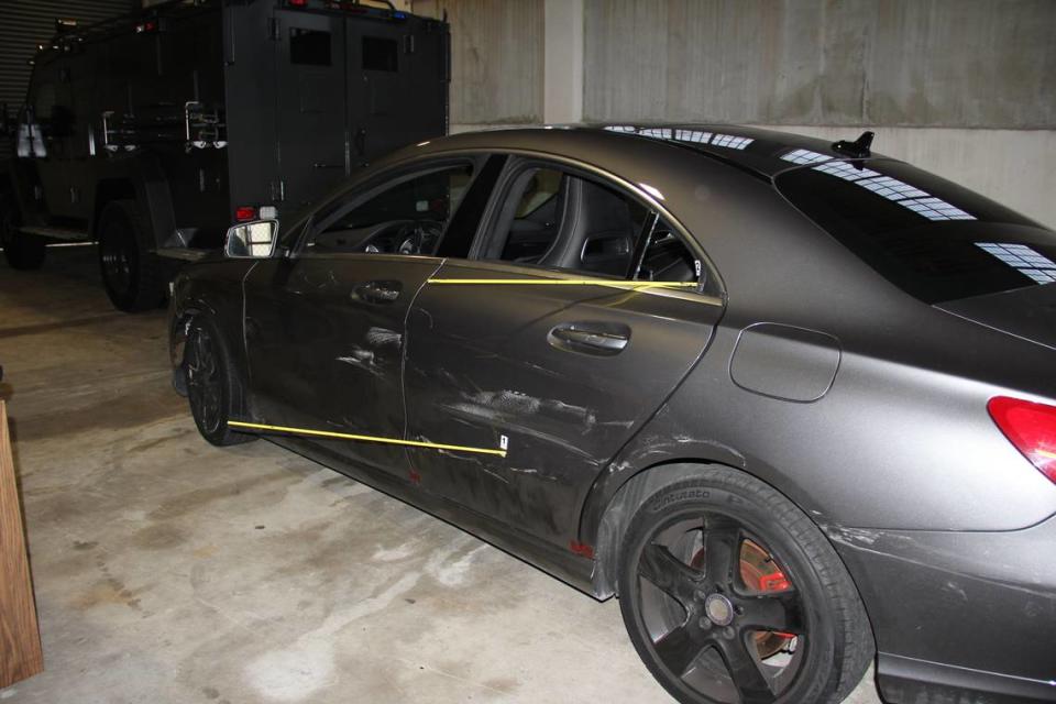 A crime-scene photo of the Mercedes-Benz believed shot at during a police chase in April 2021. What appears to be a bullet hole is in the driver’s side rear door.