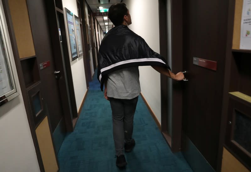 A person claiming to be a volunteer medic searches for anti-government protesters at the premises of Polytechnic University (PolyU) in Hong Kong