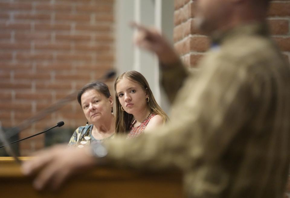 Monica Dorcey (left) and Riana Alexander listen to Chandler Unified School District board president Jason Olive respond to a question during a civic academy on youth mental health in Chandler on March 13, 2023. Alexander is a senior at Chandler High.