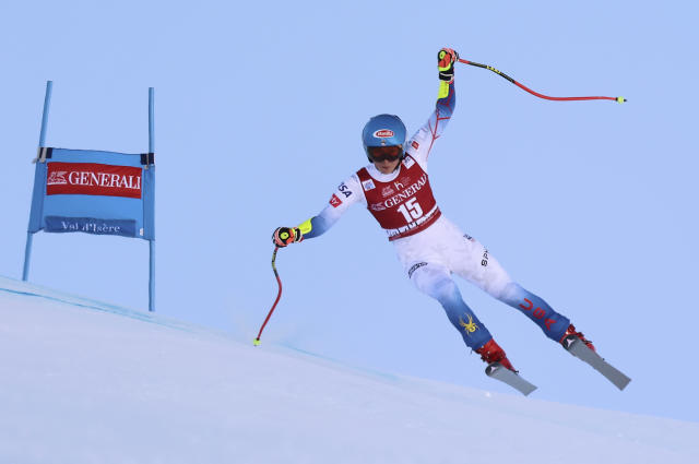 FILE - United States' Mikaela Shiffrin speeds down the course during a women's World Cup super-G skiing race in Val D'Isere, France, Dec. 19, 2021. Shiffrin is expected to enter all five individual Alpine events and be one of the main faces of the Olympics that officially open on Feb. 4. (AP Photo/Marco Trovati, File)