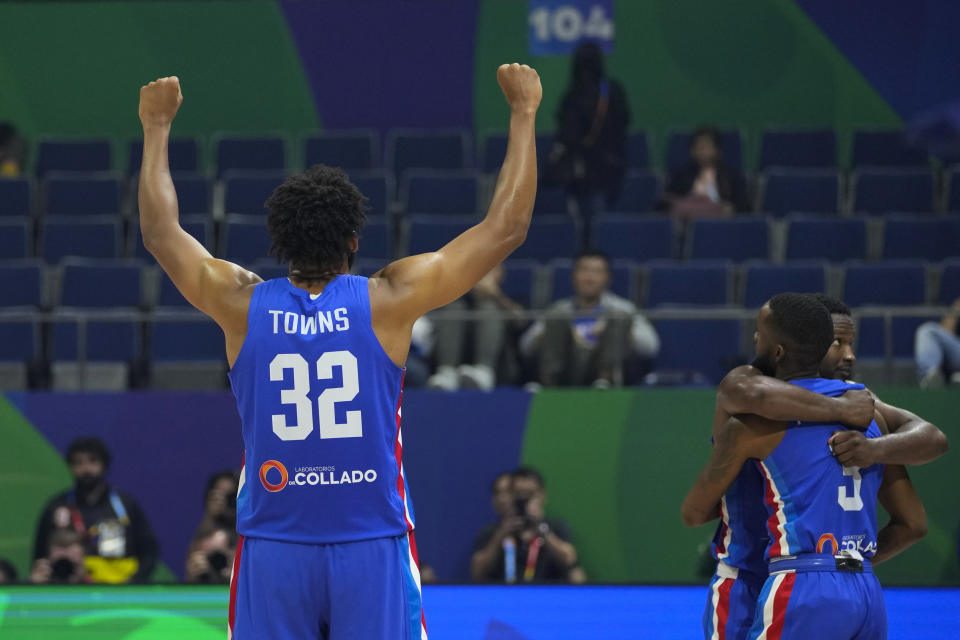 Dominican Republic forward Karl-Anthony Towns (32) and teammates celebrate after winning against Angola during their Basketball World Cup group A match at the Araneta Coliseum, Manila, Philippines on Tuesday, Aug. 29, 2023. (AP Photo/Aaron Favila)