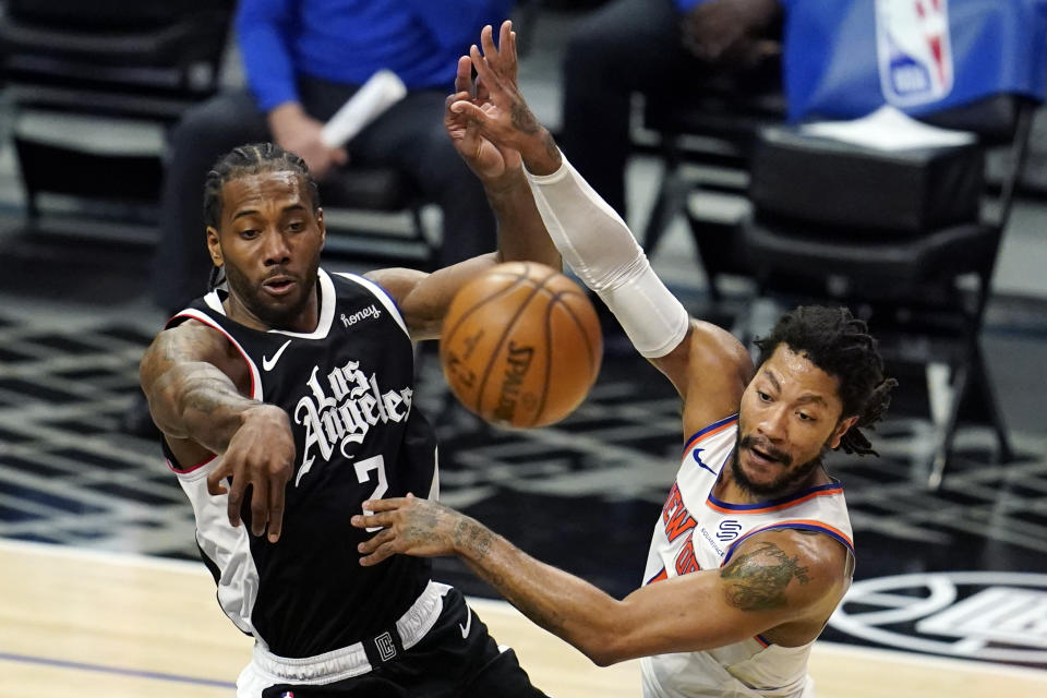 Los Angeles Clippers forward Kawhi Leonard (2) passes the ball as New York Knicks guard Derrick Rose defends during the first half of an NBA basketball game Sunday, May 9, 2021, in Los Angeles. (AP Photo/Marcio Jose Sanchez)