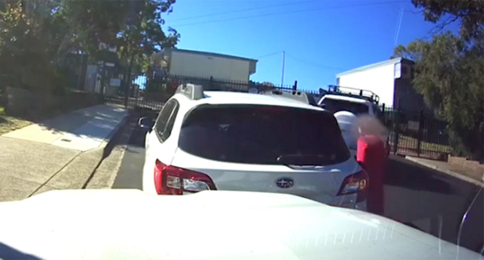 After assessing the damage, the woman gets back into her vehicle. Dash Cam Owners Australia/ Facebook