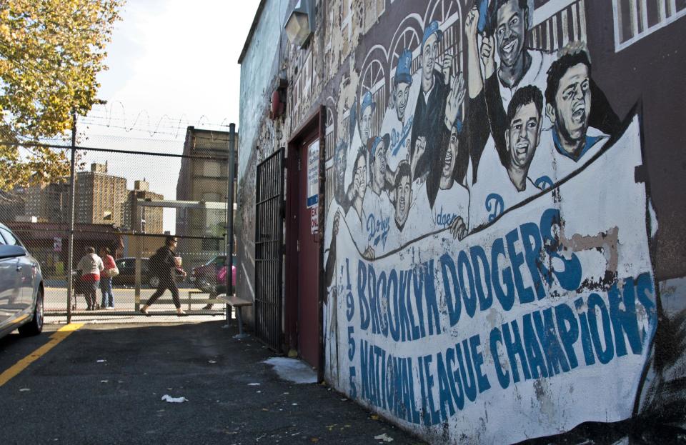 A mural recalling the Brooklyn Dodgers baseball team, shows signs of decay on the wall of a subway station on Wednesday, Sept. 19, 2012 in Brooklyn, N.Y. The mural is a short walk from Ebbets Field, where the Dodgers played and now a sprawling apartment complex to thousands after the team moved west decades ago. Now Brooklyn is back in the professional leagues again with a new arena and the Brooklyn Nets' NBA franchise. (AP Photo/Bebeto Matthews)