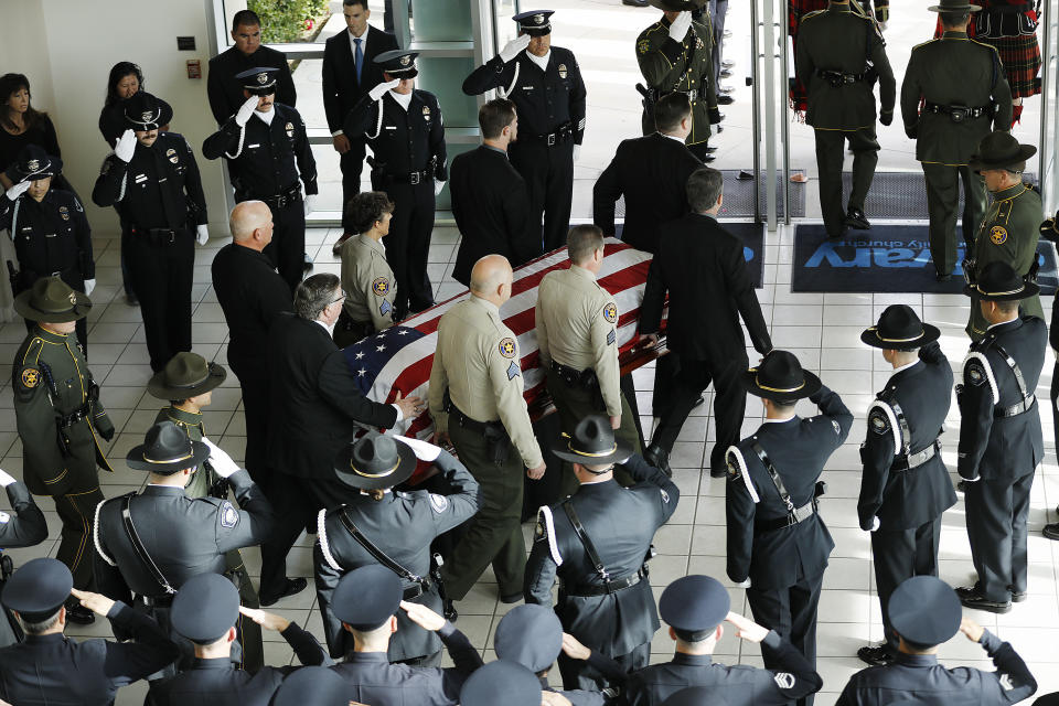 The casket with the body of Ventura County Sheriff Sgt. Ron Helus is carried out after a memorial service for Sgt. Helus at Calvary Community Church in Westlake Village, Calif., Thursday, Nov. 15, 2018. Sgt. Helus was one of twelve victims of the Borderline Bar & Grill mass shooting in Thousand Oaks last week. (Al Seib /Los Angeles Times via AP, Pool)