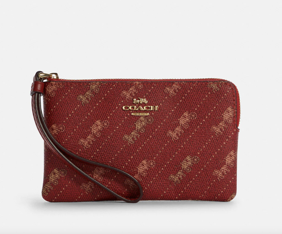 Corner Zip Wristlet with Horse and Carriage Dot Print in red and gold (Photo via Coach Outlet)