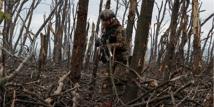 A Ukrainian serviceman inspects Russian positions after a battle, near Bakhmut, May 11, 2023