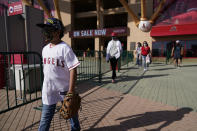 Fans leave Angel Stadium when a baseball game between the Minnesota Twins and the Los Angeles Angels was postponed Saturday, April 17, 2021, in Anaheim, Calif. MLB said the game was postponed to allow for continued COVID-19 testing and contact tracing involving members of the Twins organization. (AP Photo/Ashley Landis)