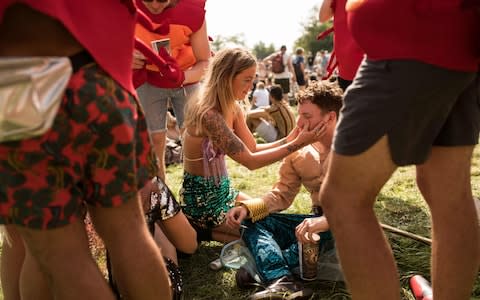 Making the most of the sun at Glastonbury - Credit: Oli Scarff/AFP