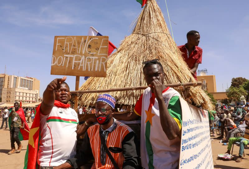 FILE PHOTO: People hold a sign to show their support to the Junta leader Ibrahim Traore and demand the departure of the French ambassador in Ouagadougou