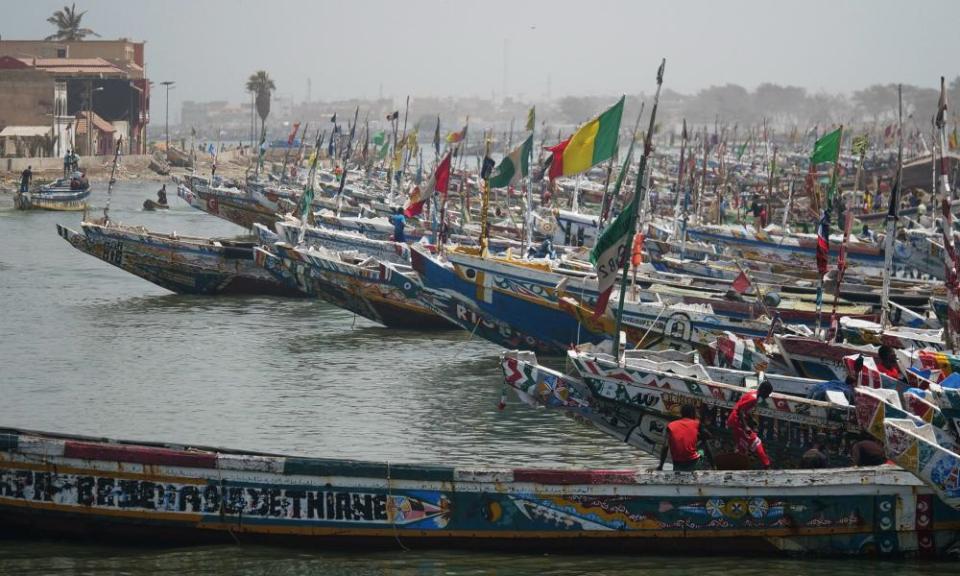 Fishing boats are seen while fishermen prepare for fishing