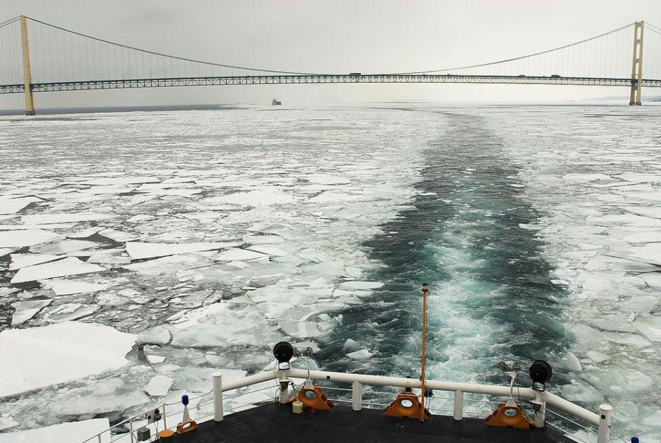 The U.S. Coast Guard Cutter Mackinaw breaks ice for freighters shipping goods around the Great Lakes during the winter.