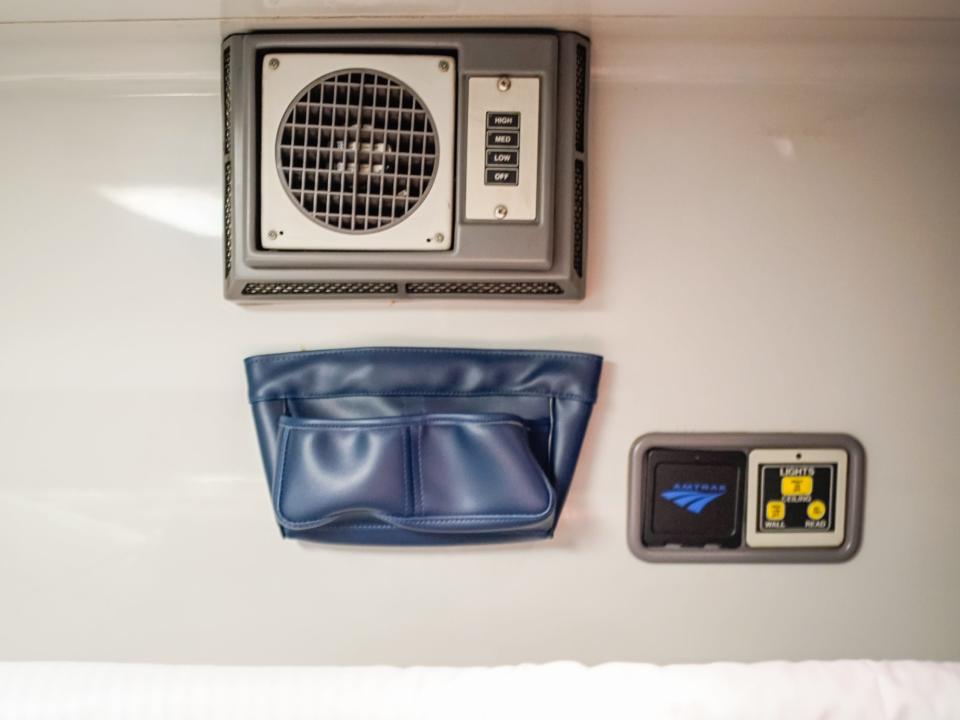 Air conditioning, a pocket for personal items, and light adjustment controls on the wall of the bedroom