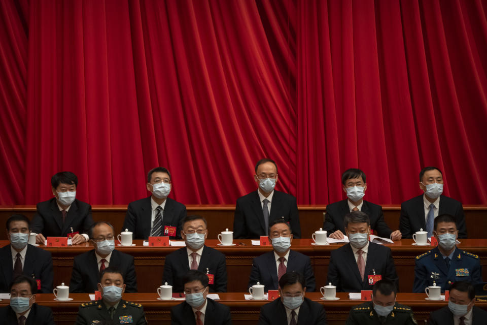 Delegates wearing face masks attend the opening ceremony of the 20th National Congress of China's ruling Communist Party in Beijing, Sunday, Oct. 16, 2022. The overarching theme emerging from China's ongoing Communist Party congress is one of continuity, not change. The weeklong meeting is expected to reappoint Xi Jinping as leader, reaffirm a commitment to his policies for the next five years and possibly elevate his status even further as one of the most powerful leaders in China's modern history. (AP Photo/Mark Schiefelbein)