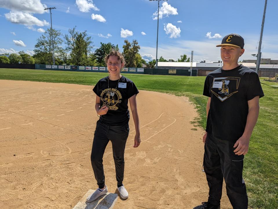 Enterprise student Morgan Romero (center) smiles after reaching safely at first with coaching from her classmate, Enterprise sophomore outfielder Porter Fischer (right) during the first Baseball 4 All at Tiger Field on Wednesday, May 3, 2023.