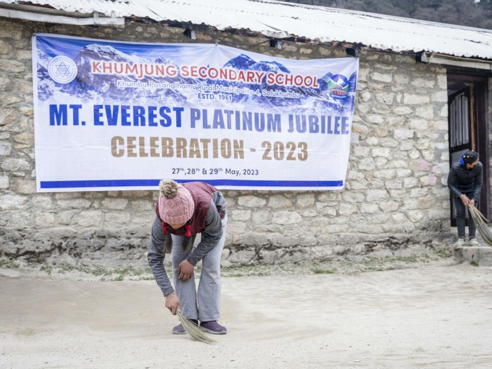 Students clean the Khumjung School which was established by Edmund Hillary, ahead of the Everest Day celebrations in the village of Khumjung, located in the shadow of Mount Everest (AFP via Getty)