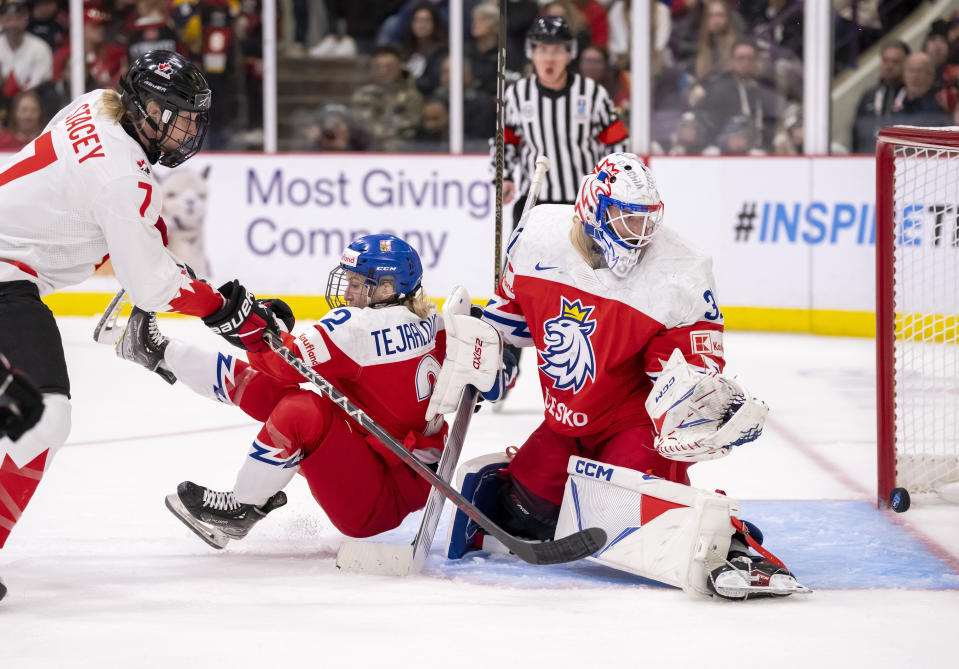 Canada forward Laura Stacey (7) shoots against Czechia defender Aneta Tejralova (2) and Czechia goaltender Blanka Skodova (31) for a goal during the second period of a women’s world hockey championships game Friday, April 7, 2023, in Brampton, Ontario. (Frank Gunn/The Canadian Press via AP)