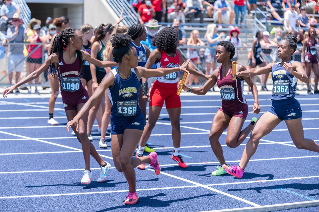 Episcopal's Nia Atcherson hands the baton off to Lauren Mack (1090) as Paxon's Adriel Strickland (1367) passes to Asia Stanford (1366) during the 2021 FHSAA track and field championships at UNF's Hodges Stadium. The FHSAA is returning its annual meet to Jacksonville this May.