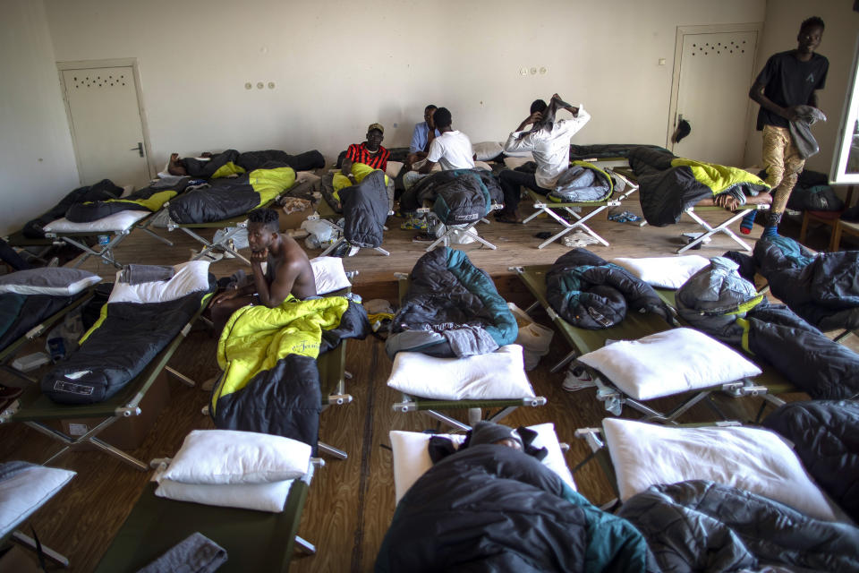 Migrants from Cameroon rest at the refugee camp in the village of Vydeniai, Lithuania, Saturday, July 10, 2021. European Union member Lithuania has declared a state of emergency due to an influx of migrants from neighboring Belarus in the last few days. Lithuania's interior minister said late Friday that the decision, proposed by the State Border Guard Service, was necessary not because of increased threats to the country of 2.8 million but to put a more robust system in place to handle migrants. (AP Photo/Mindaugas Kulbis)