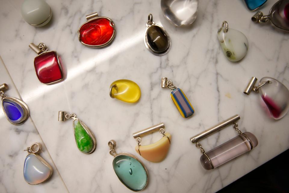 Some of the different necklace pendants made by Beth Kirk using recycled broken glass from the Pairpoint Mill fire of 1965 to make her jewelry, which can be purchased at the Kilburn Mill in New Bedford.