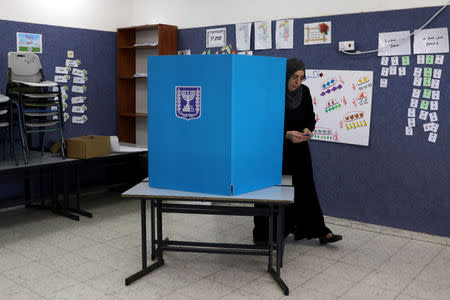 An Israeli-Arab woman walks out from behind a voting booth as Israelis vote in a parliamentary election, at a polling station in Umm al-Fahm, Israel April 9, 2019. REUTERS/Ammar Awad