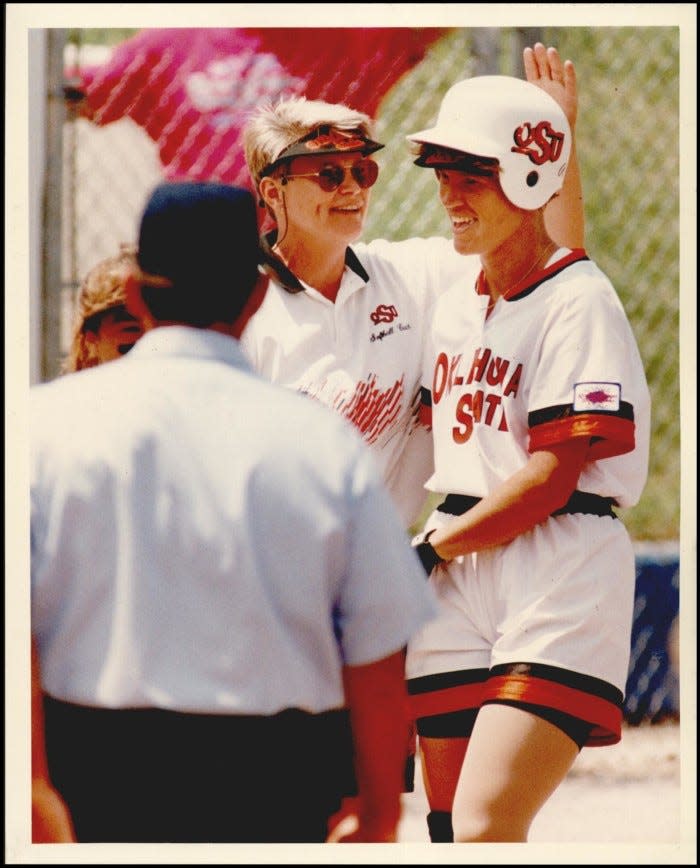 Oklahoma State softball coach Sandy Fischer congrats Kim Ward after a triple during a game in 1994.
