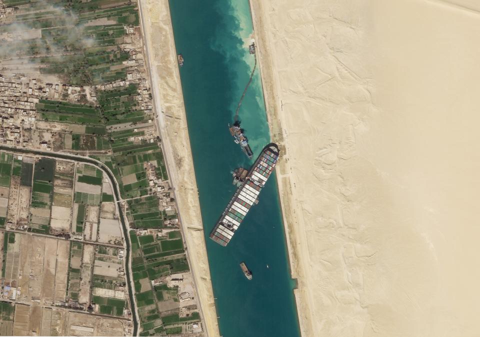 FILE - In this March 28, 2021, satellite file image from Planet Labs Inc, the cargo ship MV Ever Given sits stuck in the Suez Canal near Suez, Egypt. Consumers may face shortages and higher prices for electronics, toys, furniture and other goods should attempts to free the mammoth container ship stuck in Egypt’s Suez Canal drag on several weeks. (Planet Labs Inc. via AP)