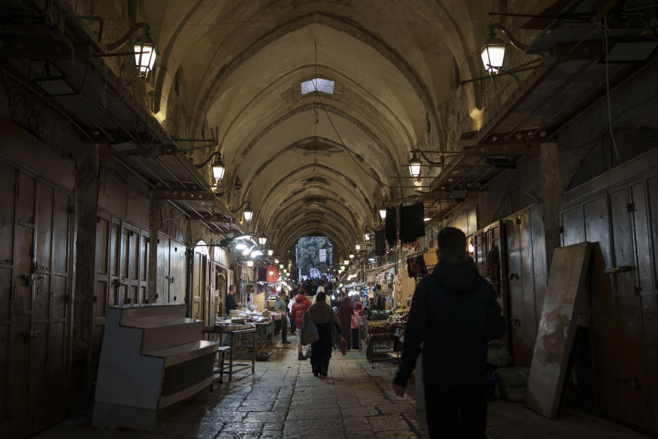 File - Palestinians walk through a market ahead of the holy Islamic month of Ramadan in the Old City of Jerusalem, Thursday, March 7, 2024. Restrictions put in place amid the Israel-Hamas war have left many Palestinians concerned they might not be able to pray at Al-Aqsa Mosque compound, which is revered by Muslims. (AP Photo/Leo Correa, File)