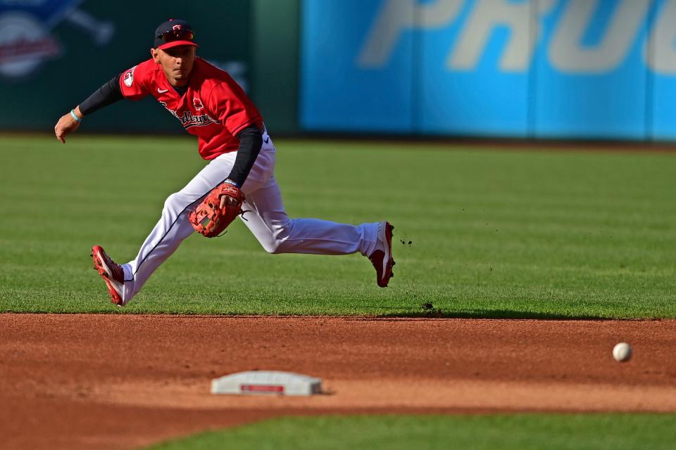 Cleveland Guardians second basemen Andres Gimenez fields a ball hit by Kansas City Royals' Whit Merrifield in the first inning of a baseball game, Monday, May 30, 2022, in Cleveland. (AP Photo/David Dermer)