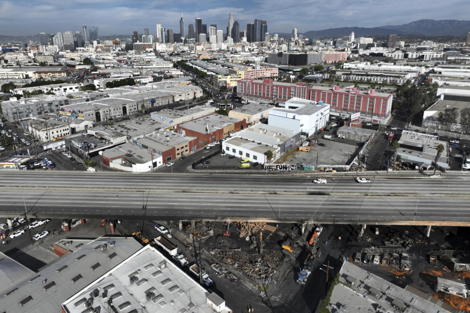 In this aerial view, Interstate 10 is empty due to a closure in the aftermath of a fire, Monday, Nov. 13, 2023, in Los Angeles. Los Angeles drivers are being tested in their first commute since a weekend fire that closed a major elevated interstate near downtown. (AP Photo/Jae C. Hong)