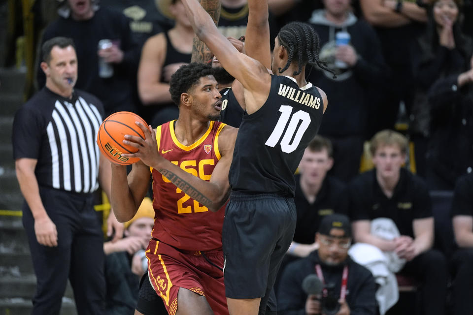 Southern California forward Arrinten Page, left, is trapped with the ball by Colorado forward Cody Williams, front right, and center Eddie Lampkin Jr. during the second half of an NCAA college basketball game Saturday, Jan. 13, 2024, in Boulder, Colo. (AP Photo/David Zalubowski)