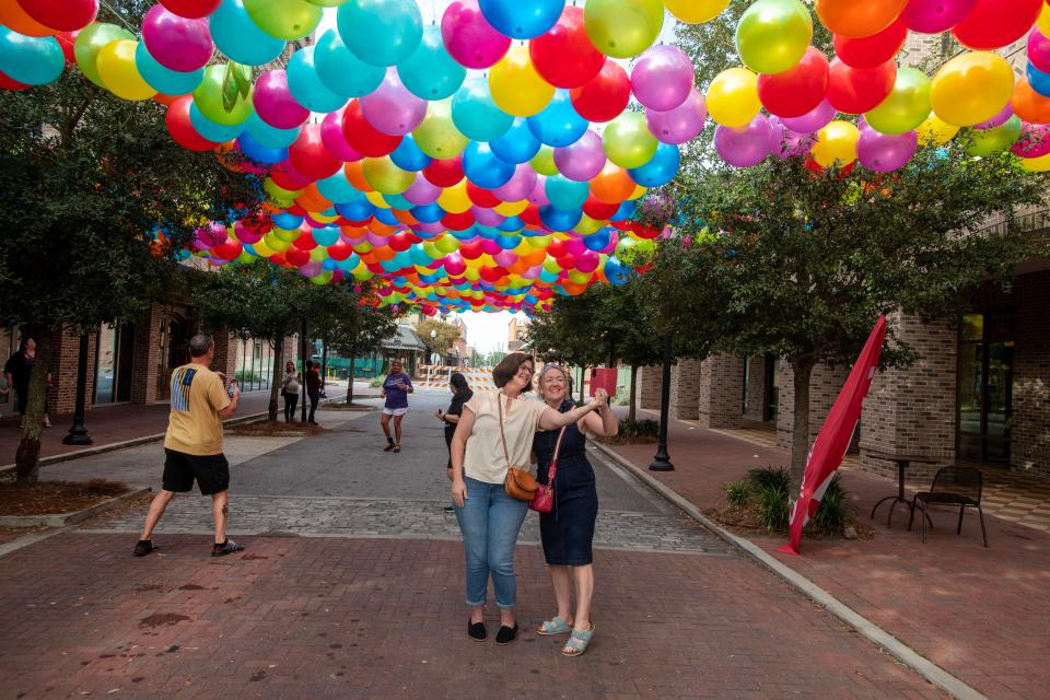 Visitors check out the FooFoo Fest Balloon Exhibit in Downtown Pensacola Saturday, November 5, 2022.