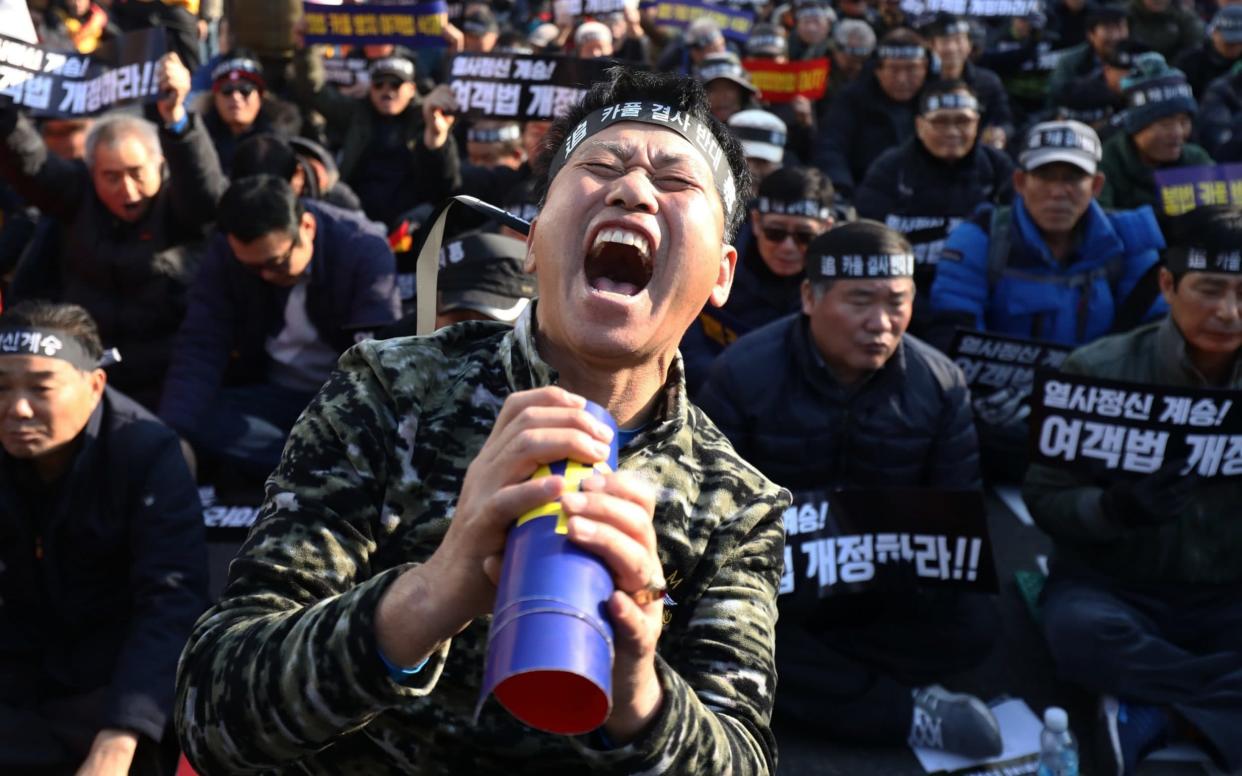 South Korean taxi drivers participate in a rally calling for the car-pooling app to be banned in front of the National Assembly on December 20, 2018 in Seoul - Getty Images AsiaPac