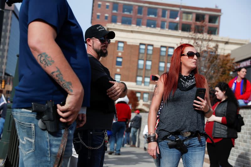 People carry firearms outside the TCF Center as supporters of U.S. President Donald Trump rally as votes continue to be counted following the 2020 U.S. presidential election, in Detroit