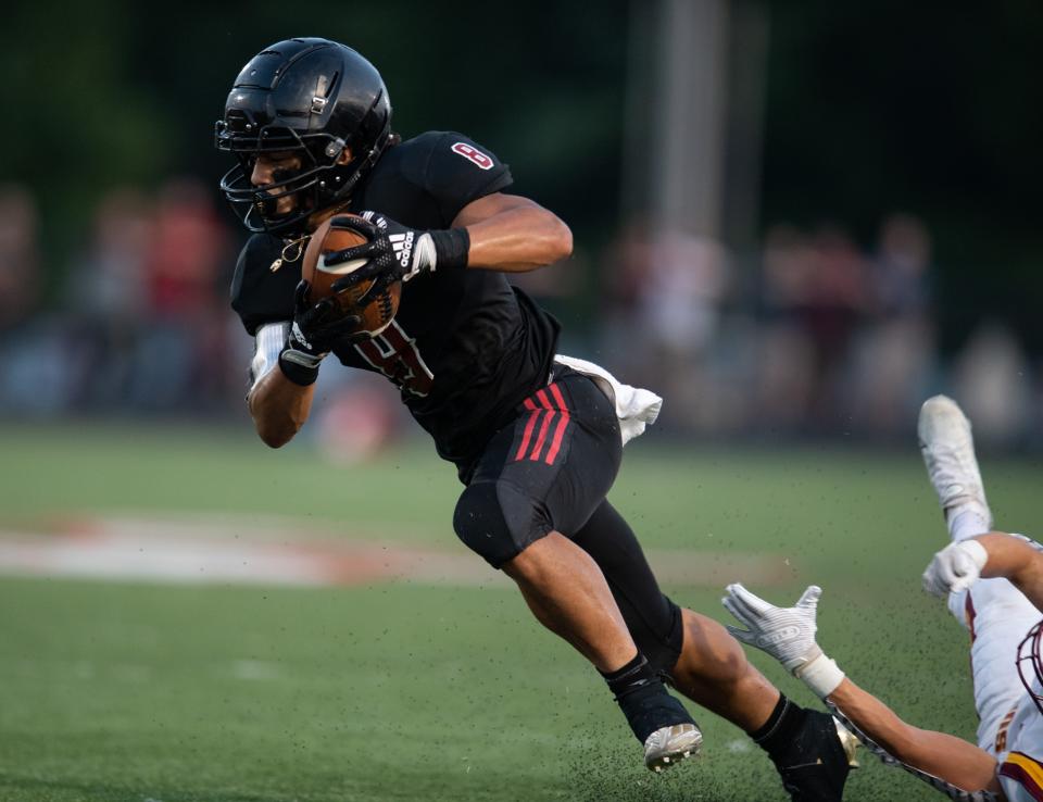 Southridge's Yamil Arroyo (8) escapes from Gibson Southern Titans defenders as the Southridge Raiders play the Gibson Southern Titans at Southridge High School in Huntingburg, Ind., Friday evening, Sept. 16, 2022. 