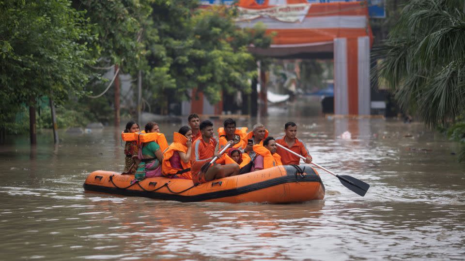 Members of the National Disaster Response Force (NDRF) evacuate stranded residents from a flooded locality, after a rise in the water level of the Yamuna River, in New Delhi on July 13, 2023. - Adnan Abidi/Reuters