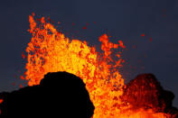 Lava from the Kilauea volcano shoots out of a fissure, in the Leilani Estates near Pahoa, Hawaii, U.S., May 26, 2018. REUTERS/Marco Garcia
