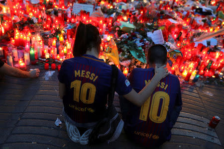 People gather at an impromptu memorial where a van crashed into pedestrians at Las Ramblas in Barcelona, Spain, August 20, 2017. REUTERS/Susana Vera