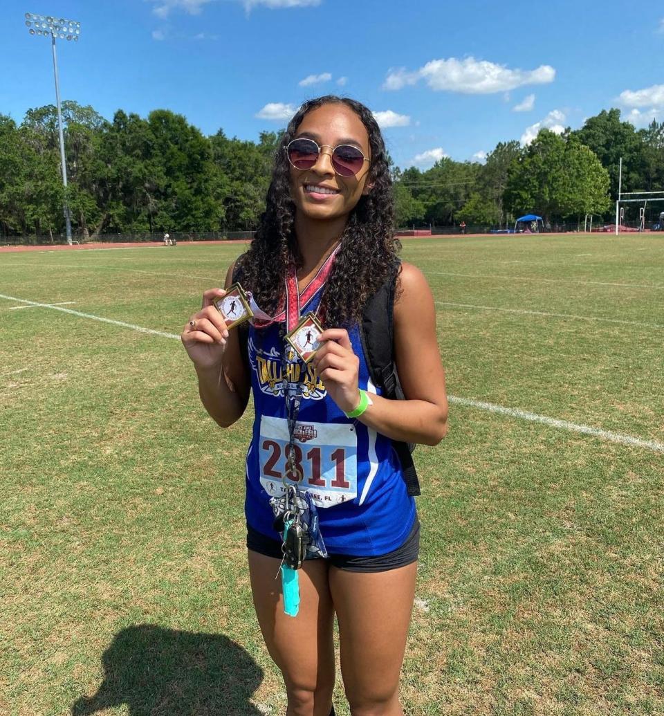 Tallahassee Community College women's track and field freshman Lynette Scutari shows off her medals won at the Alice Sims Invitational at Florida High School in Tallahassee, Florida, Saturday, May 13, 2023